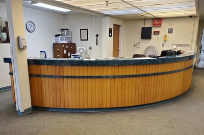 Reception area with a curved wooden desk