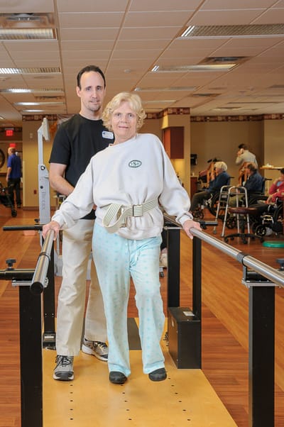 Residents engaging in physical therapy in an activity room