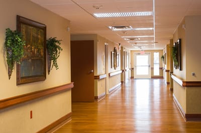 A hallway with paintings in a senior living facility