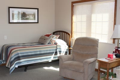 Cozy resident room with a bed and a recliner