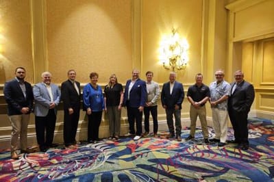 Group of people posing together in a conference room
