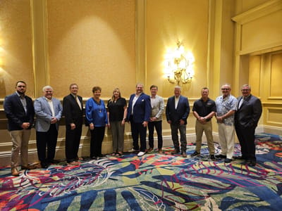 Group of people posing in a formal indoor setting