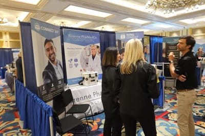 People interacting at a promotional booth in an indoor setting