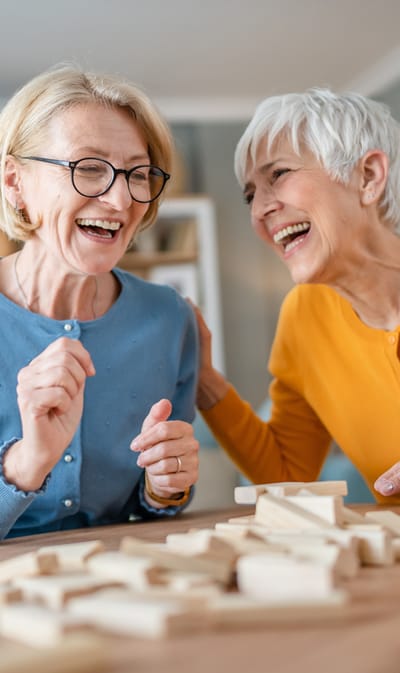 St. Andrew’s Apartments at Kirksville, independent living in Kirksville, MO — Two smiling senior women enjoying a game together