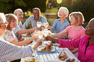 St. Andrew’s Apartments at Kirksville, independent living in Kirksville, MO — Seniors toasting with glasses during an outdoor meal