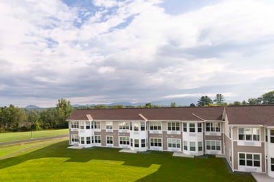 Exterior view of the nursing home building with green space
