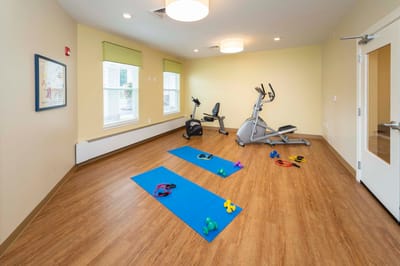 Fitness room with exercise equipment and mats