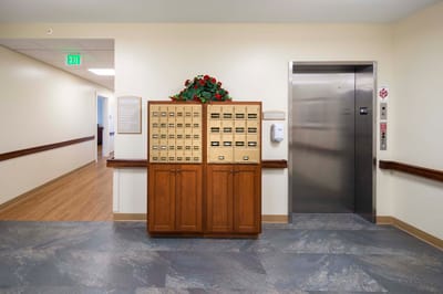 Interior view of a hallway with elevator and directory