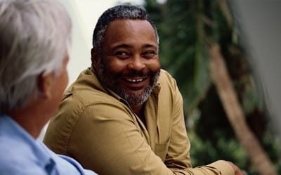 Two residents enjoying a conversation outdoors