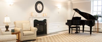 Interior view of a common area with piano and seating