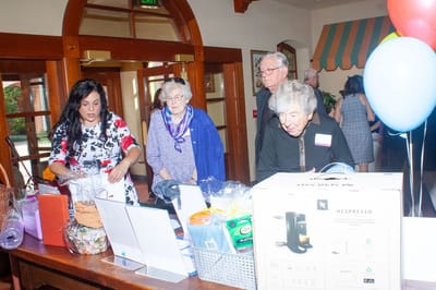 Residents and staff engaging in an event with gifts displayed