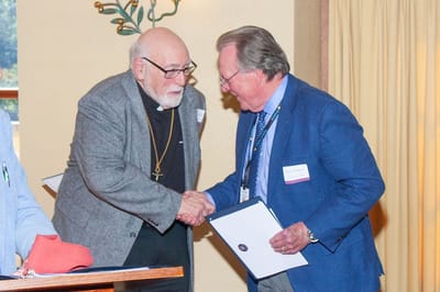 Two men shaking hands during an event