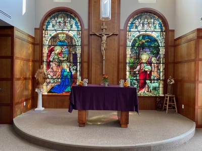 Interior view of a chapel with stained glass windows