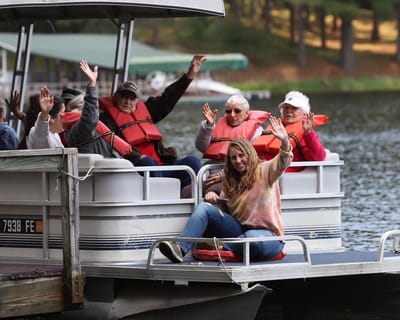 Residents and staff enjoying a boat ride on the lake