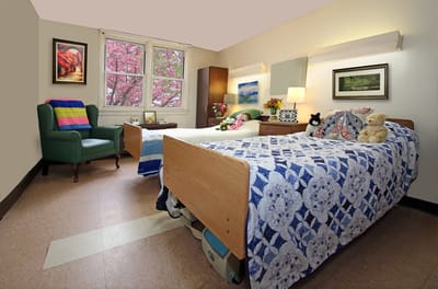 Cozy resident room with twin beds and artwork