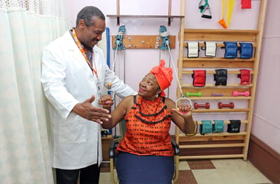 Therapist assisting a resident in a rehabilitation session