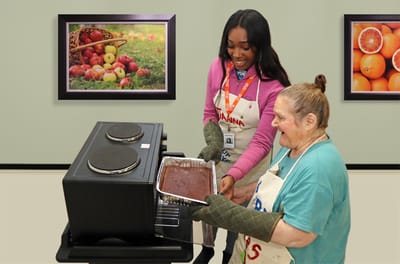 Residents baking together in a kitchen activity