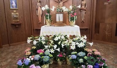 Chapel altar decorated with flowers and religious statues