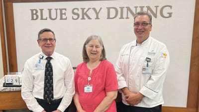 Staff and resident smiling at Blue Sky Dining