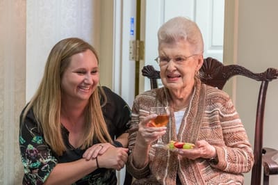 A staff member enjoying time with a resident