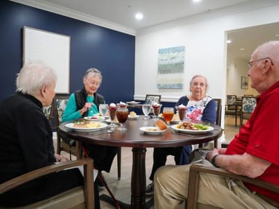 Residents enjoying meals together in the dining room