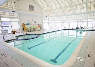 Indoor swimming pool area with large windows