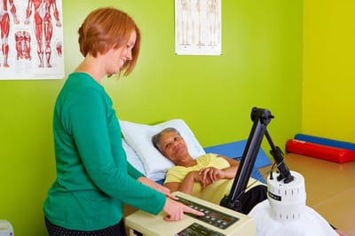 Therapist assisting a resident in a treatment room