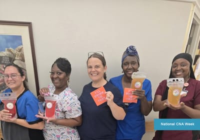 Staff celebrating National CNA Week with drinks