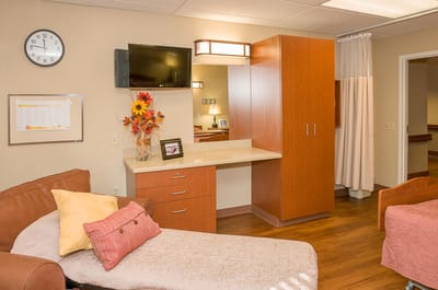 Cozy resident room with twin beds and a TV
