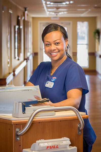 Staff member smiling at the reception desk