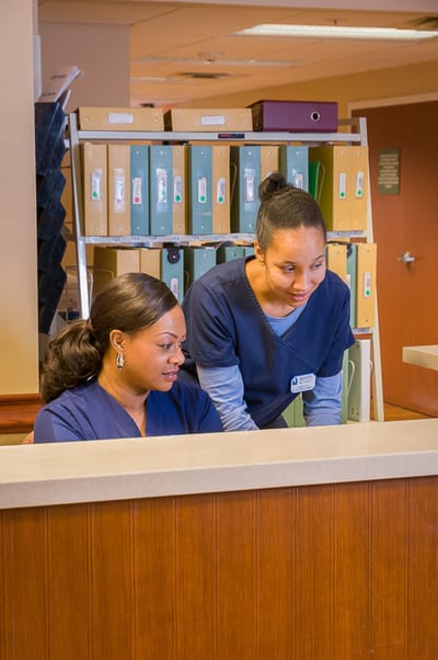 Staff members collaborating at a reception area