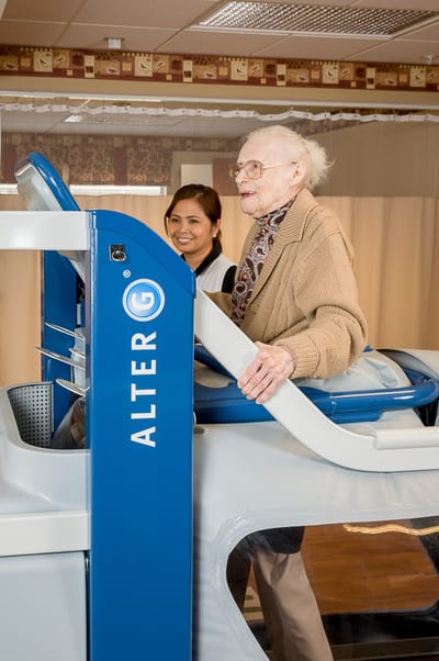 Senior resident engaging with staff in a therapy session