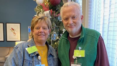 Staff members posing in a decorated common area