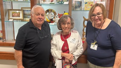 Residents and staff posing together in a common area