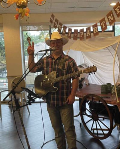 A musician performing at a celebration in the facility