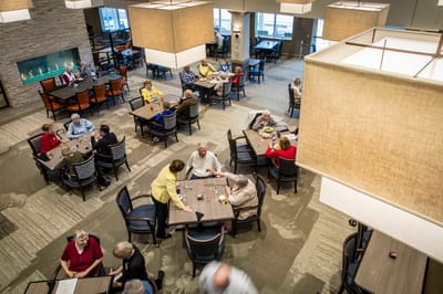 Residents enjoying meals in a dining area
