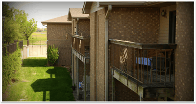 Outdoor corridor with grassy area and trees