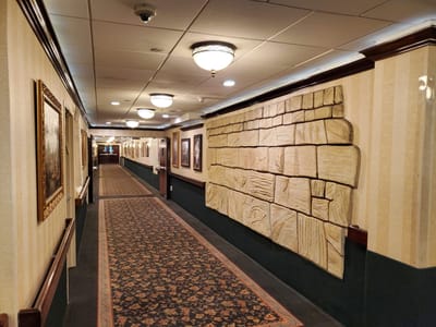 Interior hallway with decorative wall and framed pictures