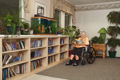 Resident reading in a cozy indoor space