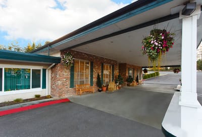 Exterior view of the facility entrance with hanging plants
