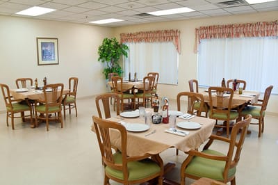 Dining area with tables and chairs set for a meal