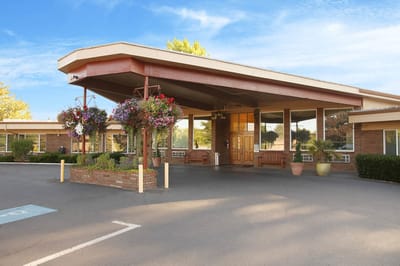 Exterior view of Life Care Center of McMinnville with flowers