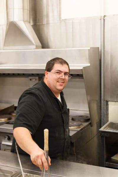 Cook preparing food in a commercial kitchen