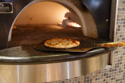 Pizza baking in a stone oven