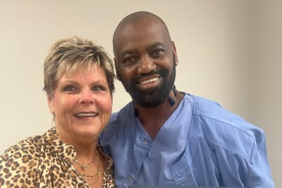 Staff member and resident smiling together