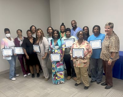 Staff and residents celebrating awards in a common area