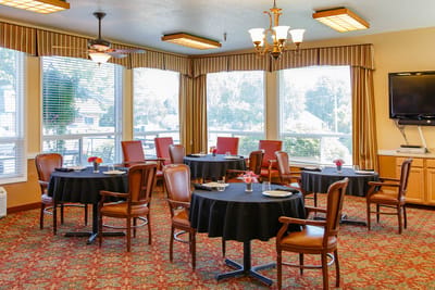 Dining area with tables and chairs set for meals