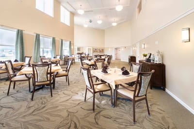 Interior dining room with tables and chairs set for meals