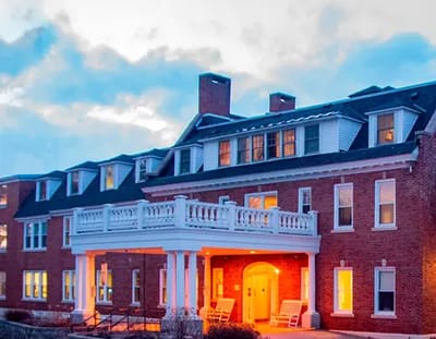 Exterior view of a nursing home building at dusk