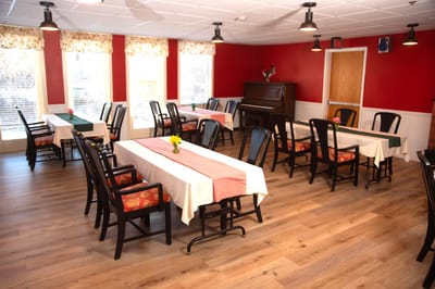 Dining room with tables set for residents